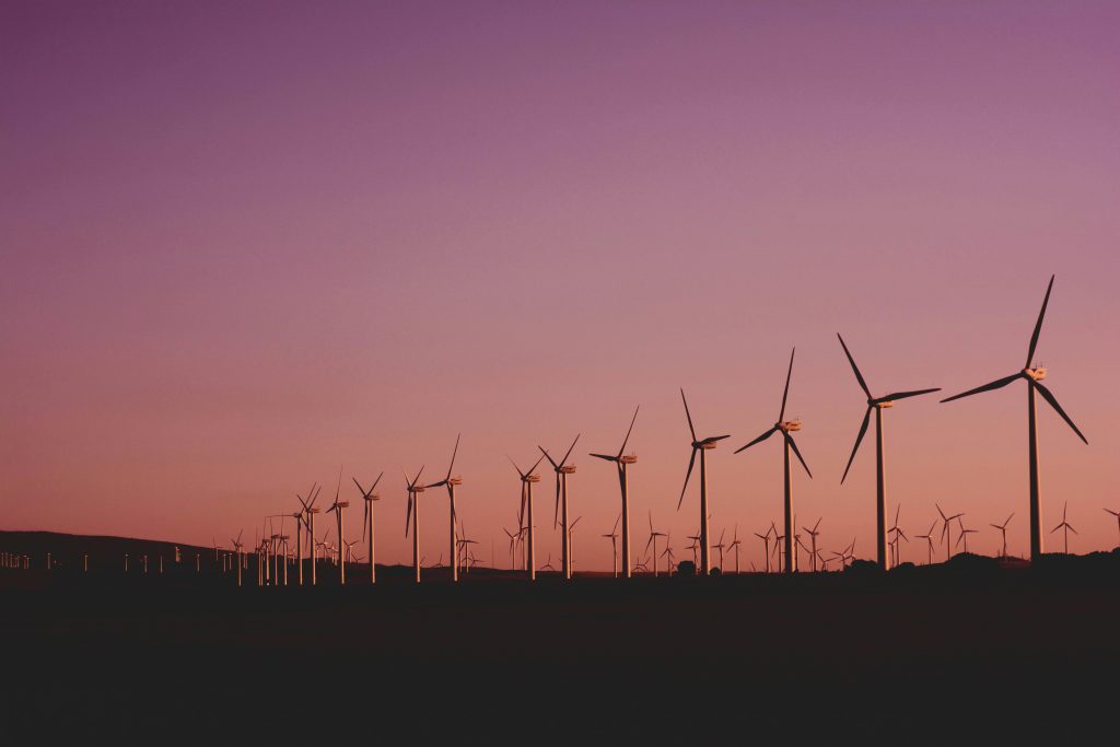 Implementación de Sistema de Radiocomunicaciones Digital MOTOTRBO en Parque eólico SARCO. Silhouetted wind turbines at sunset in Zahara de los Atunes, Spain.